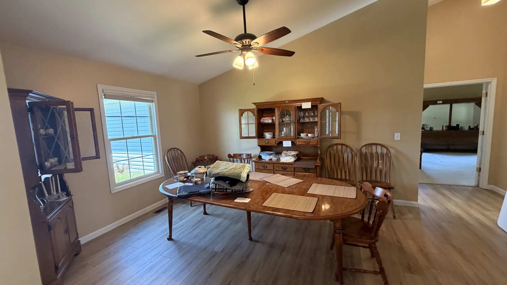 Dining room oak table hutch corner cabinet ceiling fan at an estate sale Dardenne Prairie
