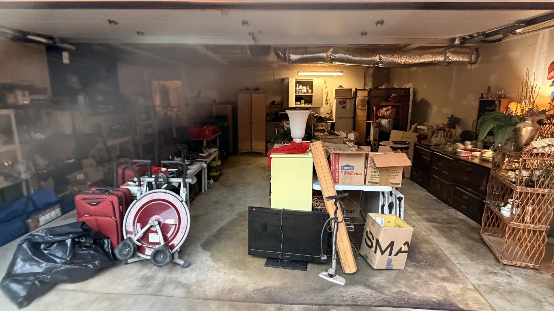 Gallery/garage exercise bike luggage boxes at an estate sale Wentzville