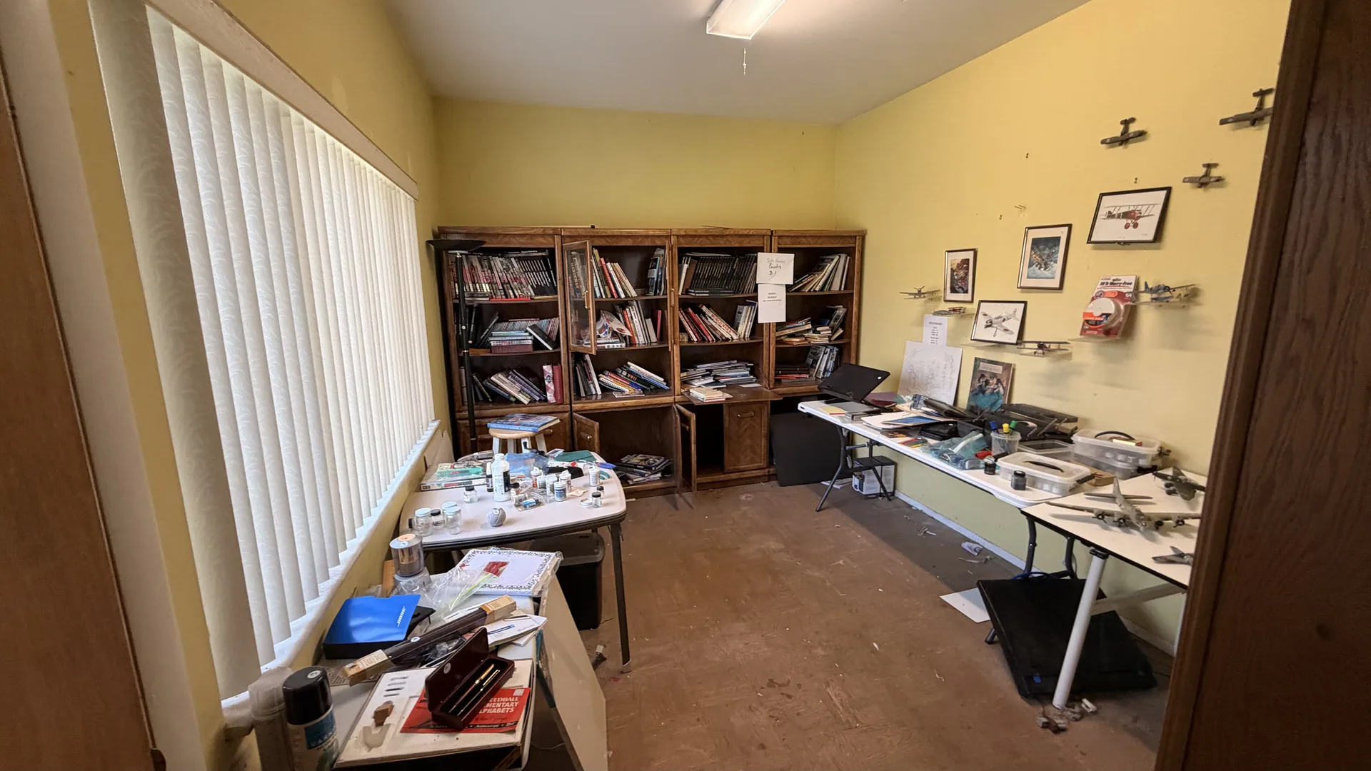 Gallery/hobby room model airplanes bookcases at an estate sale O'Fallon