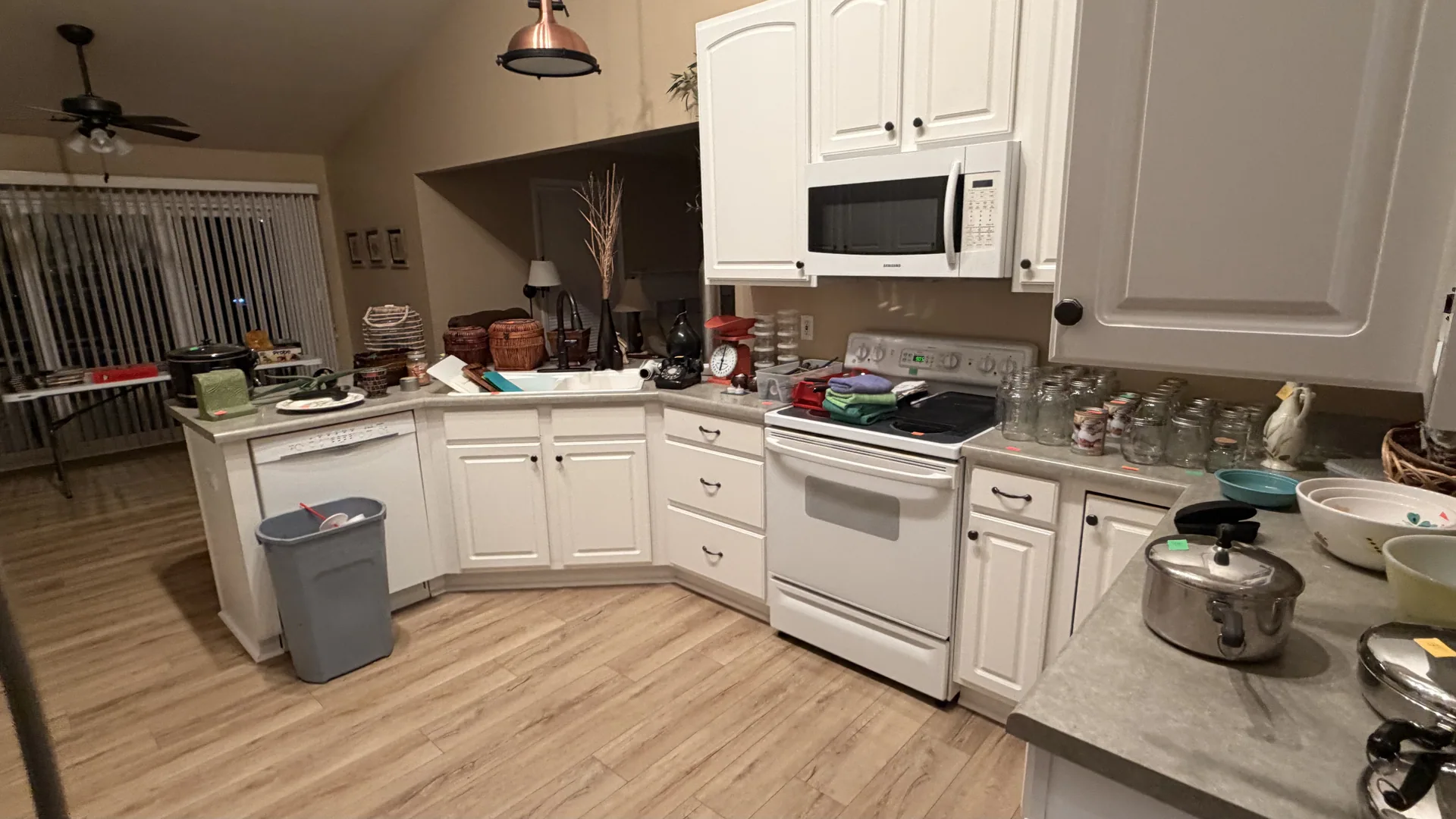 Kitchen white cabinets mason jars stockpots at an estate sale O'Fallon