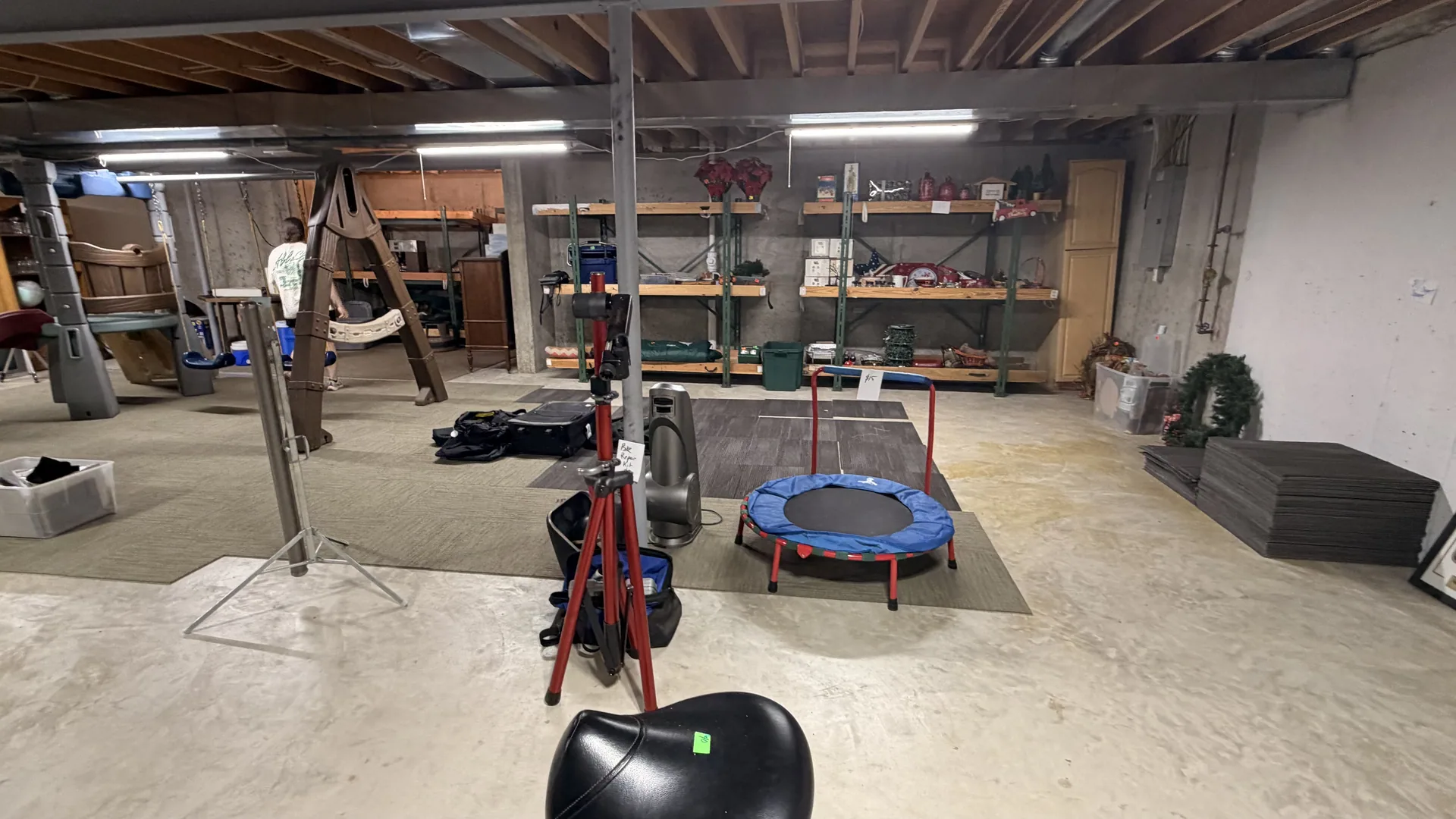 Unfinished basement mini trampoline wooden swing set at an estate sale O'Fallon